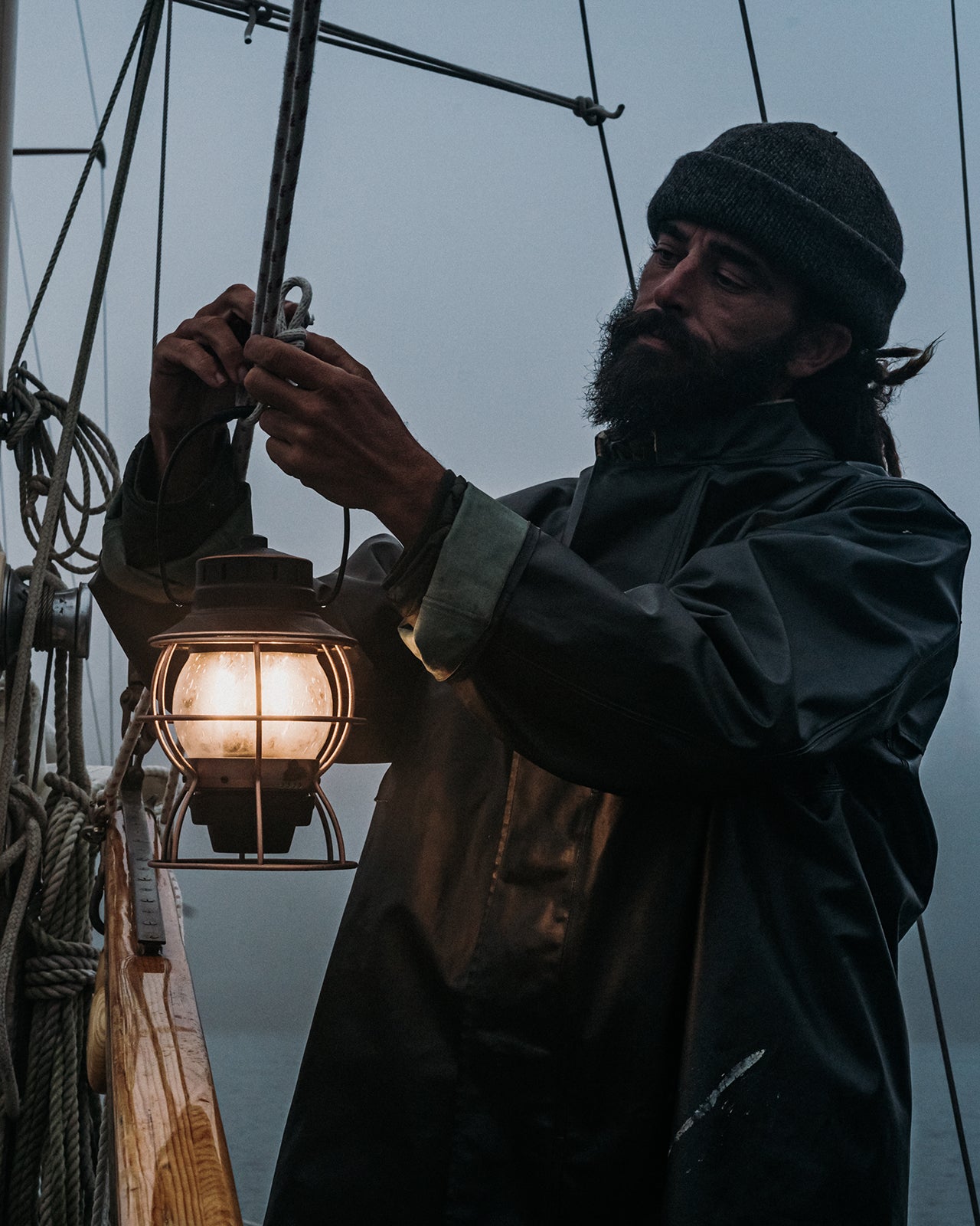 Bearded fisherman hanging a Railroad Lantern.